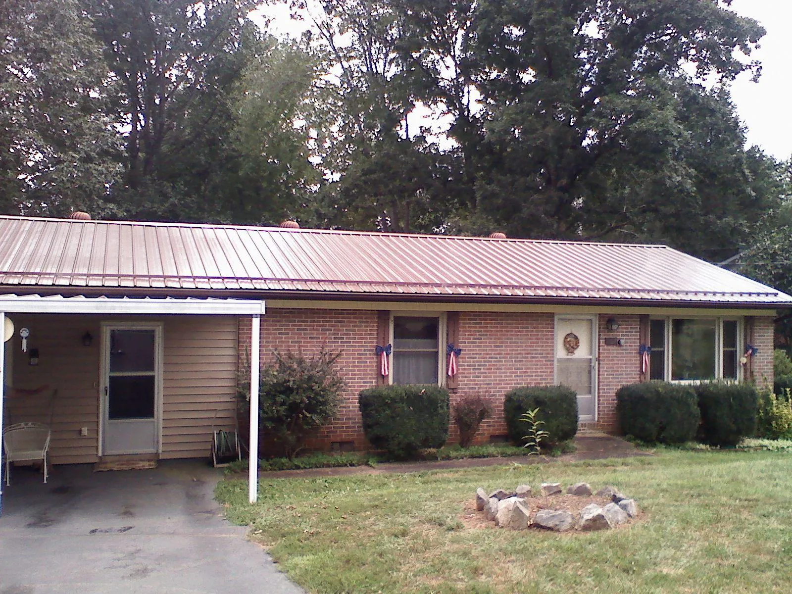 Bronze metal roof and carport on a brick ranch home — Roof Repair work by our crew in Willow Grove